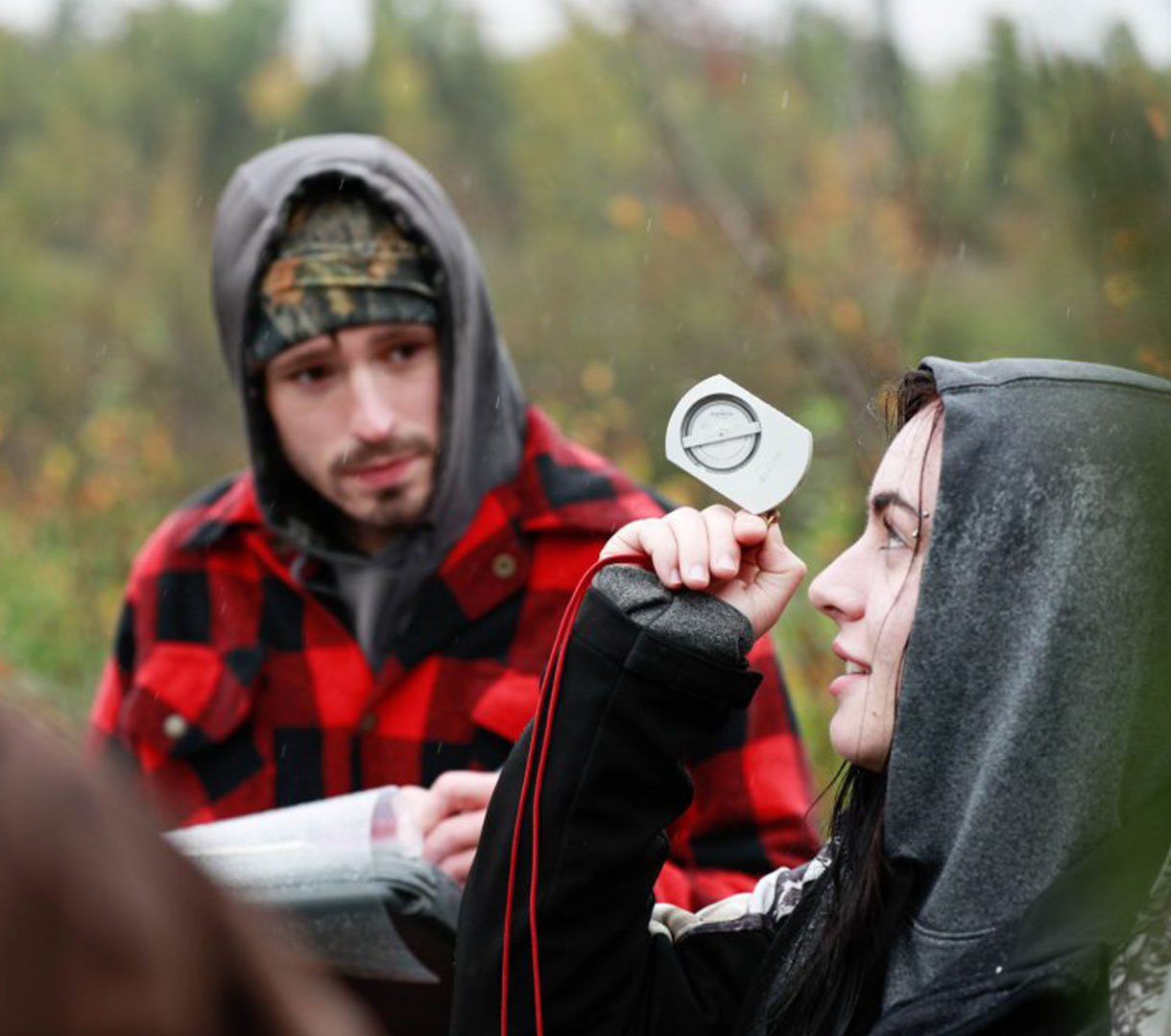 Student using a compass outdoors