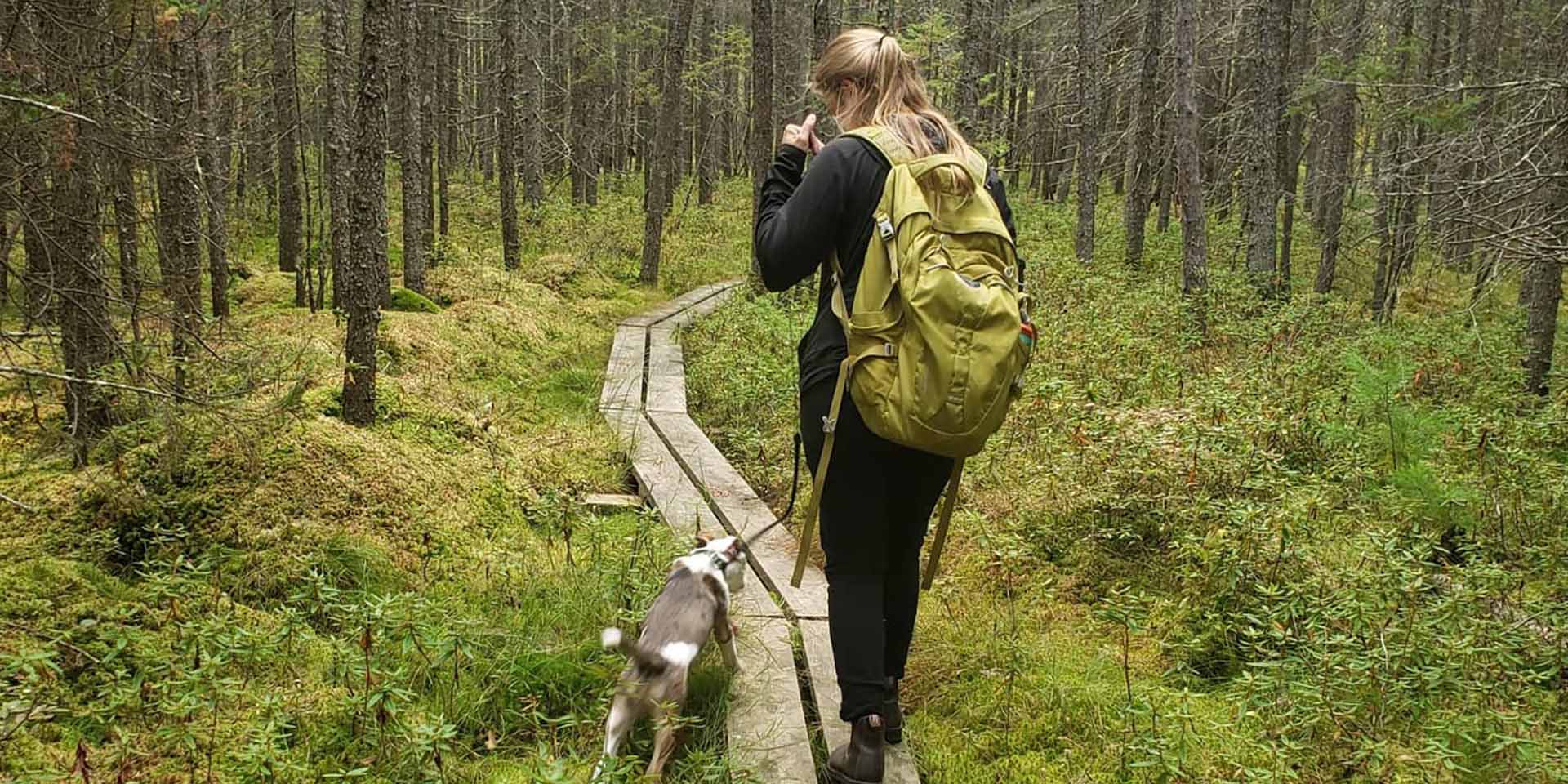 Student on a trail with her dog