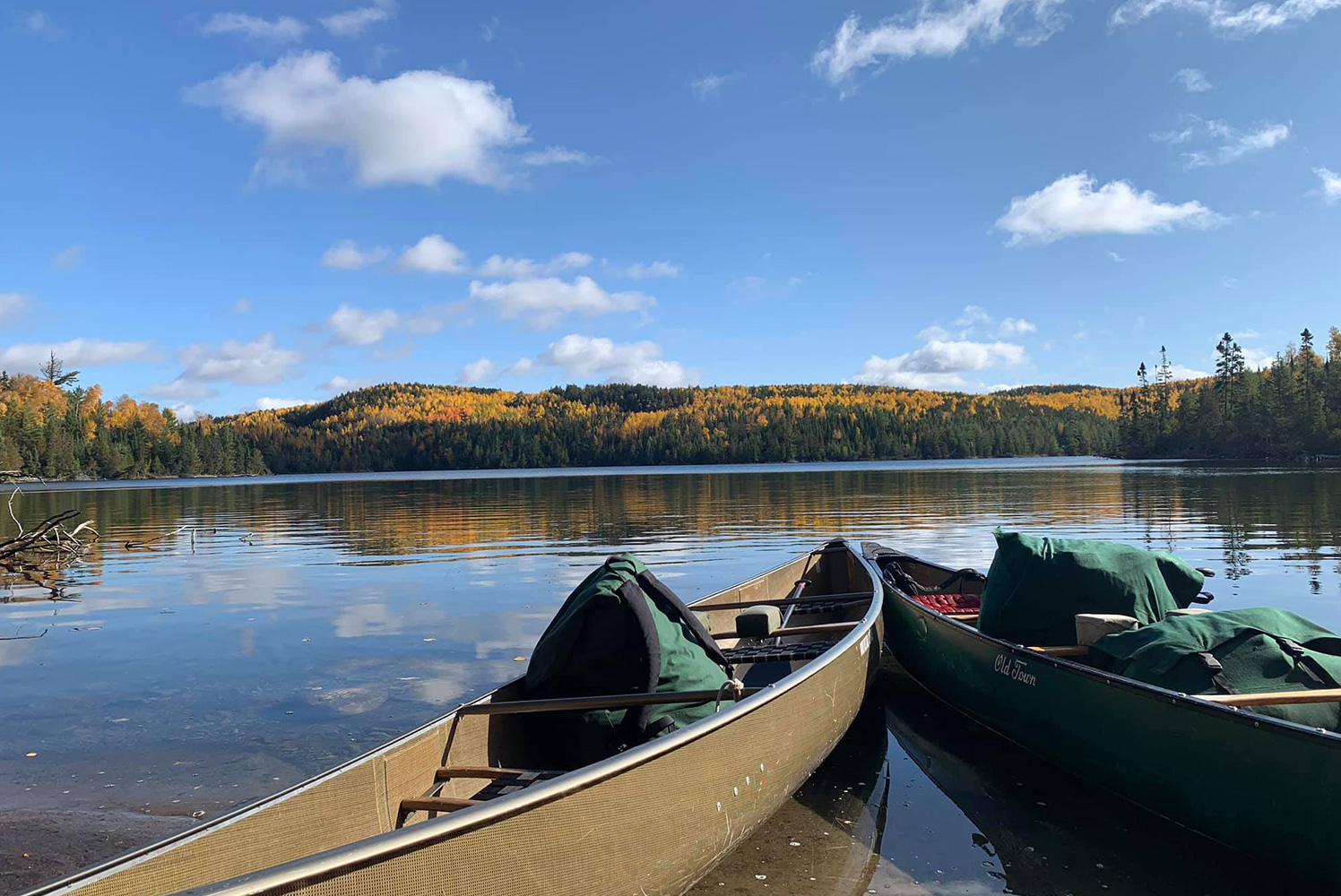 two canoes outside on a lake