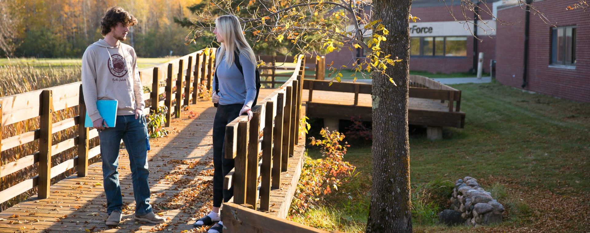 Two students having a discussion on campus.