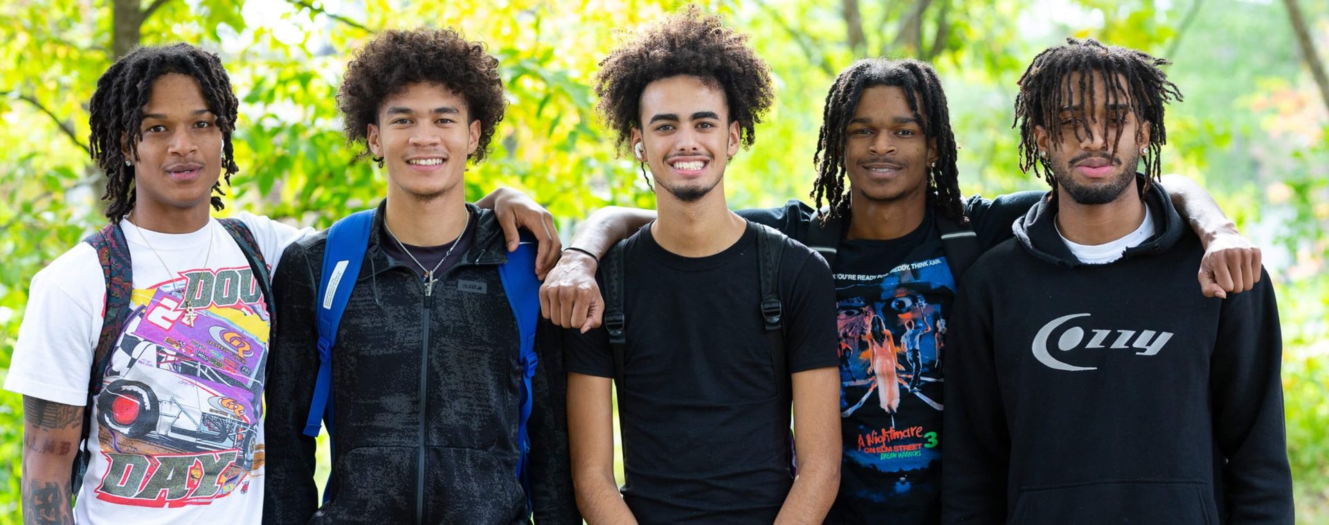 Several students posing for a photo outside.