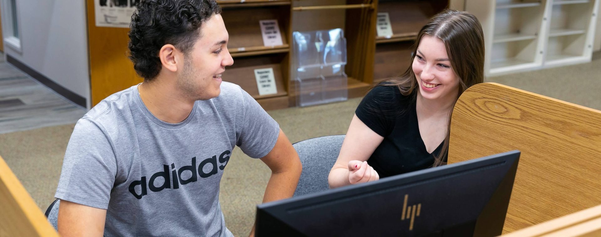 Two students on a computer.