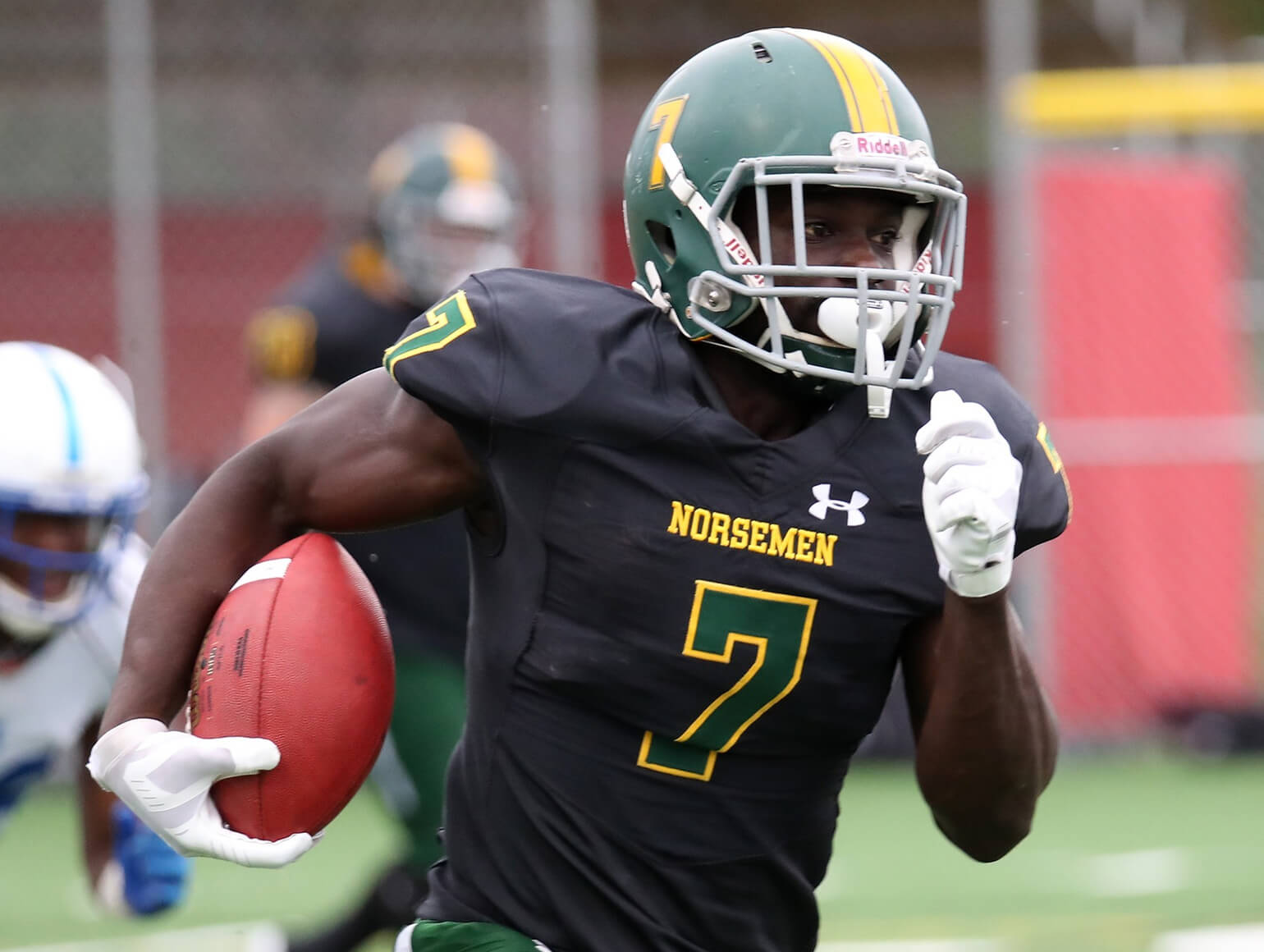 Mesabi Range football player running.