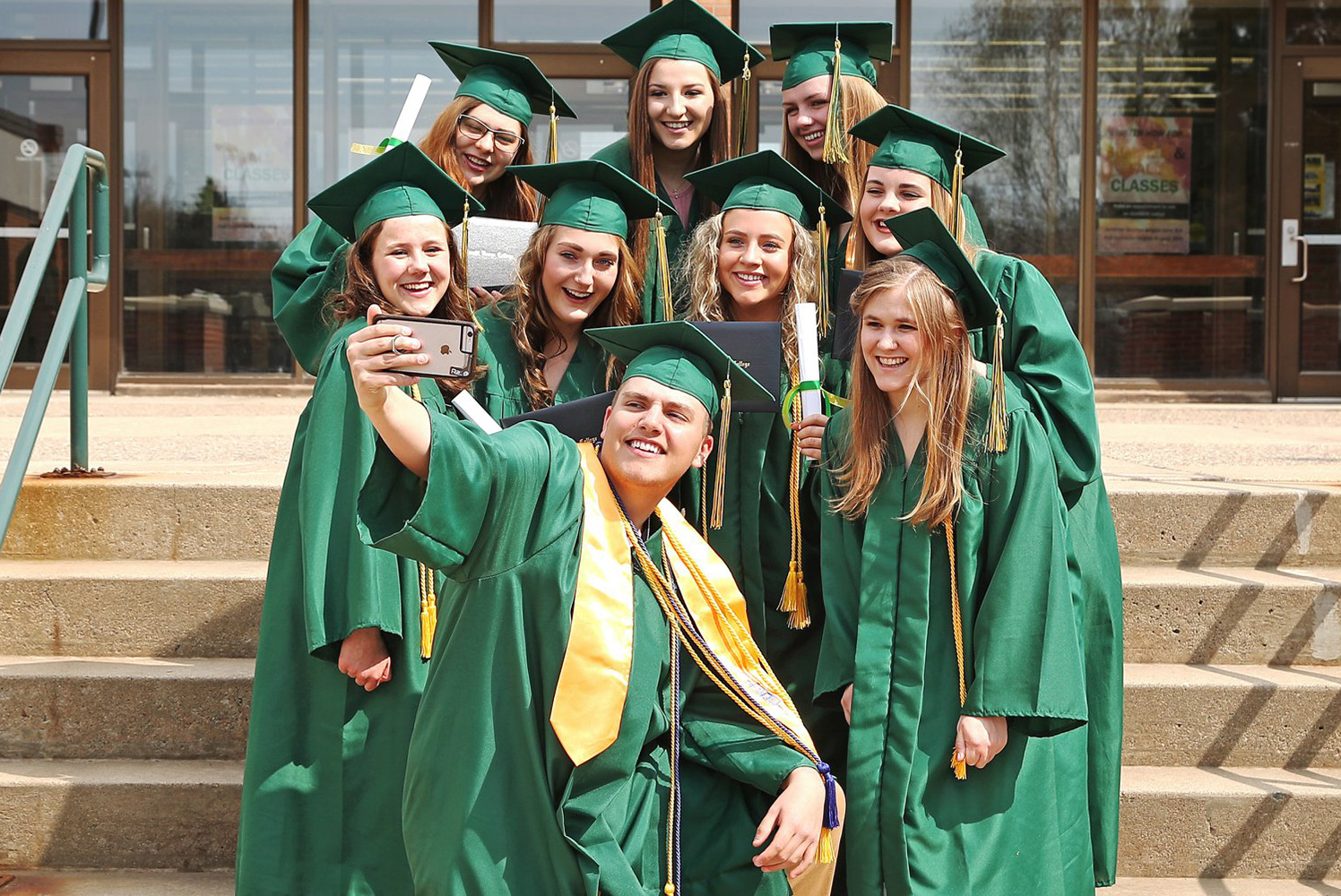 Students posing for a graduation selfie.