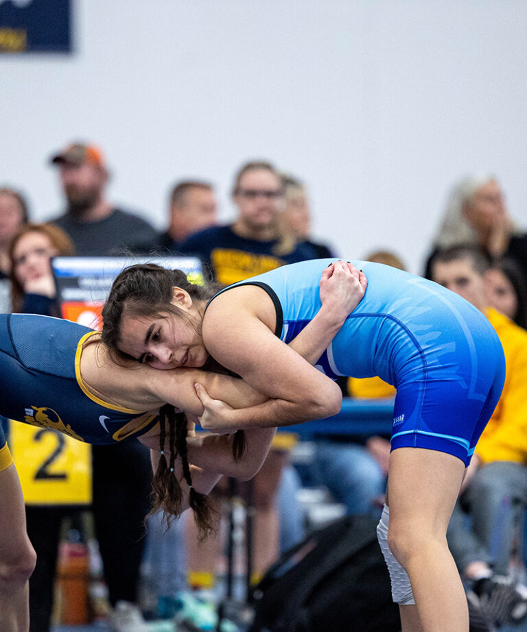 female wrestler with blue singlet